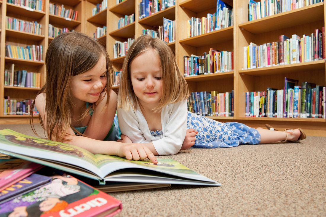 children-on a library-reading-a-book